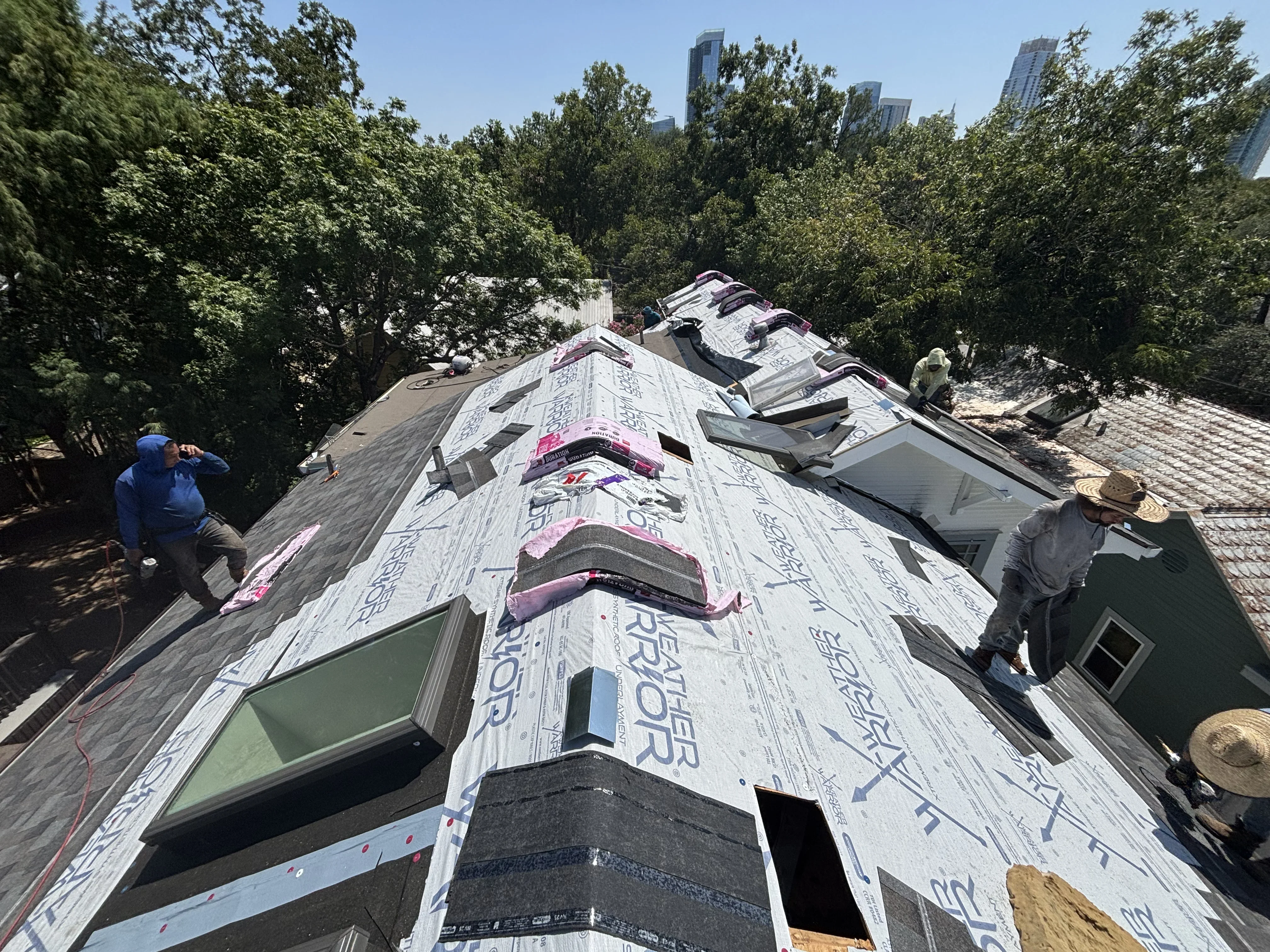 Residential roof replacement with synthetic underlayment and asphalt shingles installation in progress